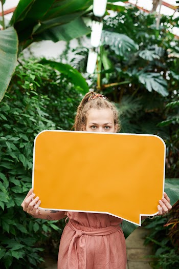 Photo of Woman Holding Blank Signboard