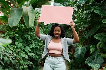 Photo of Woman Holding Blank Signboard