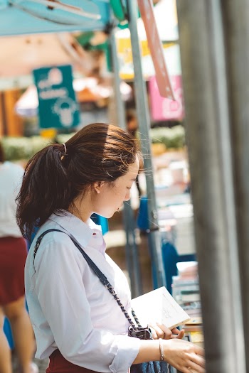 Photo of Woman Holding Book