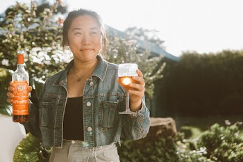 Photo of Woman Holding Bottle And Wine Glass