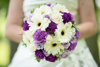 Photo of Woman Holding Bouquet of Flowers