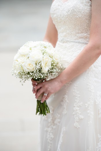 Photo of Woman Holding Bouquet of Flowers