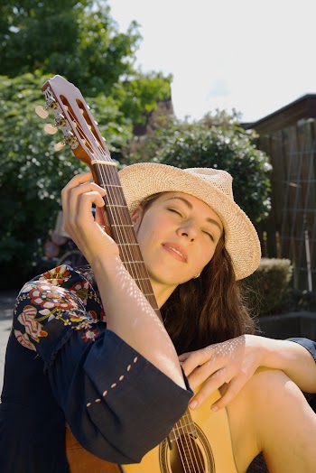Photo Of Woman Holding Brown Guitar