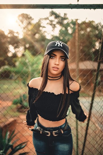 Photo Of Woman Holding Chain Link Fence