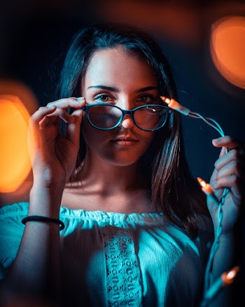 Photo of Woman Holding Christmas Lights