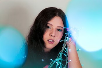 Photo of Woman Holding Christmas Lights