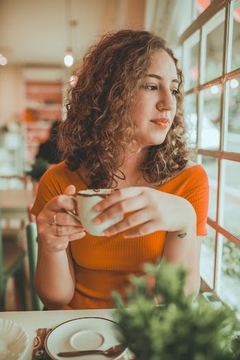 Photo of Woman Holding Cup