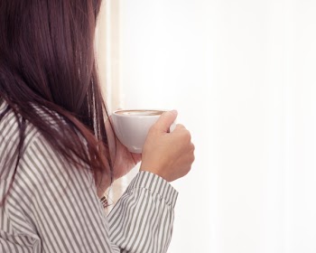 Photo of Woman Holding Cup of Coffee