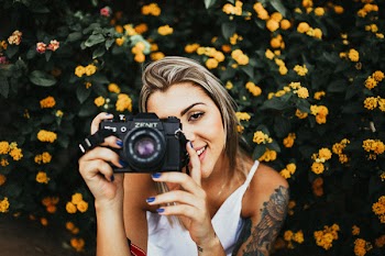 Photo of Woman Holding DSLR Camera