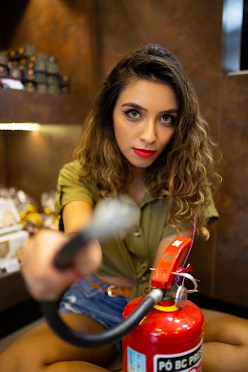 Photo of Woman Holding Fire Extinguisher