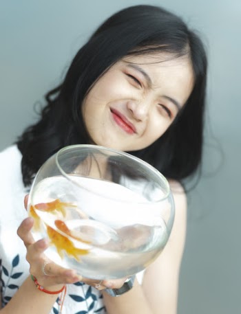 Photo of Woman Holding Fish Bowl