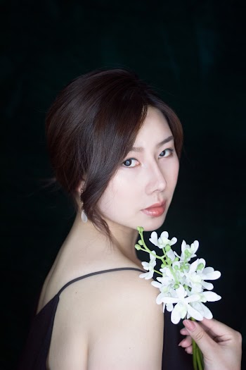 Photo Of Woman Holding Flowers