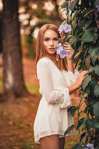 Photo Of Woman Holding Flowers