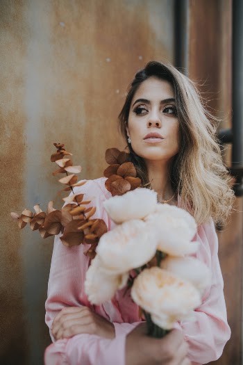 Photo of Woman Holding Flowers