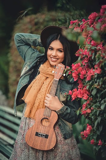 Photo Of Woman Holding Guitar