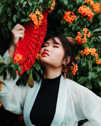 Photo Of Woman Holding Hand Fan