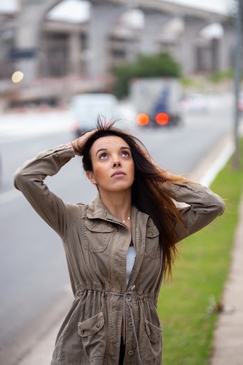 Photo of Woman Holding Her Hair While Looking Upwards