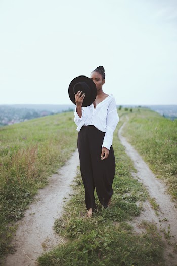 Photo of Woman Holding Her Hat