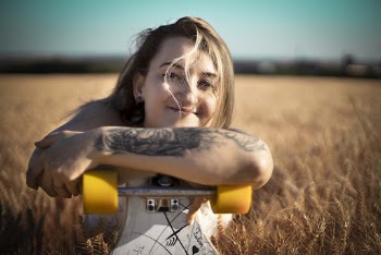 Photo Of Woman Holding Her Skateboard