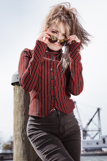 Photo Of Woman Holding Her Sunglasses