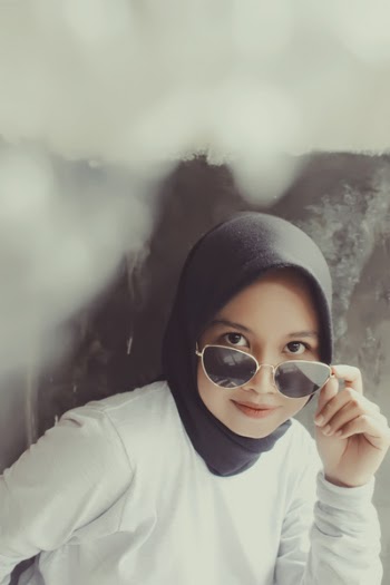 Photo of Woman Holding Her Sunglasses