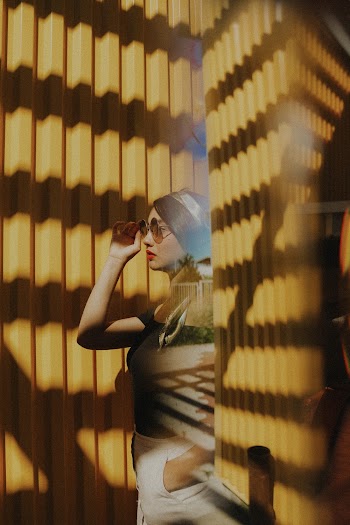 Photo Of Woman Holding Her Sunglasses
