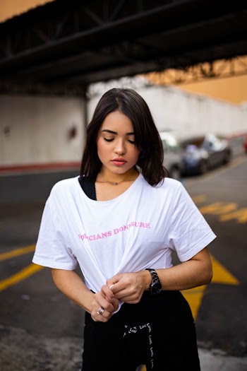 Photo of Woman Holding Her White Shirt