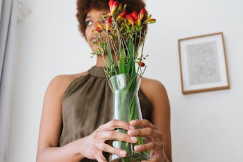 Photo Of Woman Holding Indoor Plant