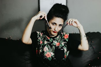 Photo of Woman Holding Makeup Brushes