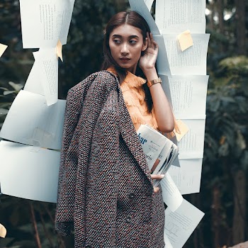 Photo Of Woman Holding Newspapers