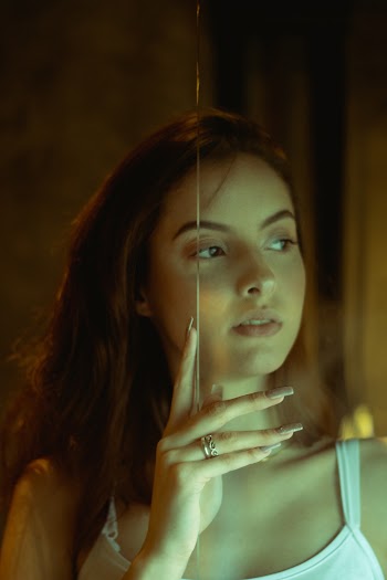 Photo of Woman Holding On Glass