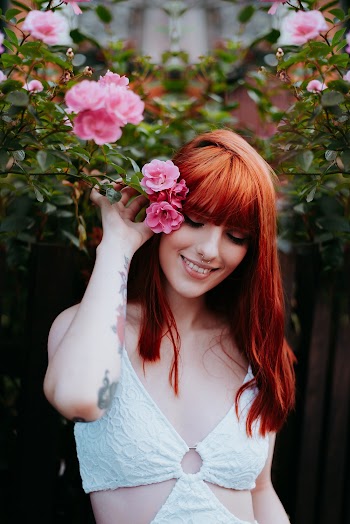Photo of Woman Holding Pink Flowers