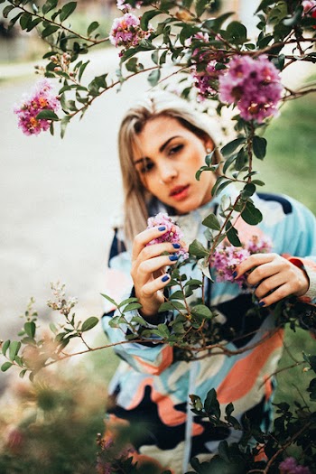 Photo of Woman Holding Pink Flowers