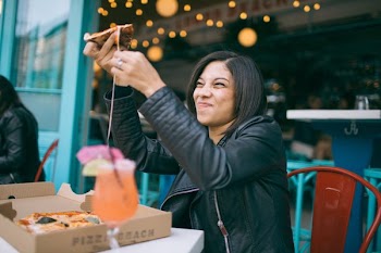 Photo of Woman Holding Pizza