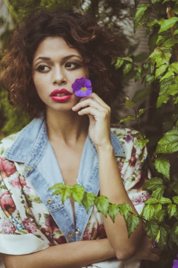Photo of Woman Holding Purple Flower
