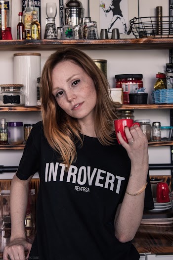 Photo of Woman Holding Red Coffee Cup Posing In the Kitchen