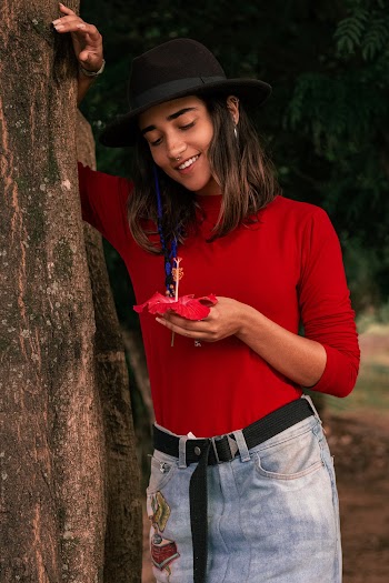 Photo Of Woman Holding Red Flower