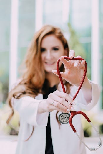 Photo Of Woman Holding Red Stethoscope