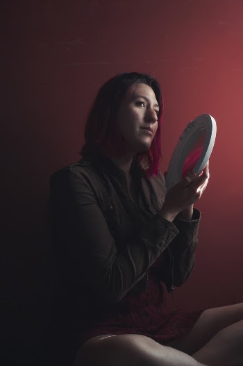 Photo of Woman Holding Round White-framed Mirror