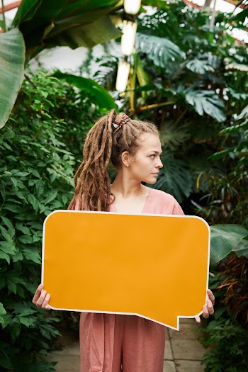 Photo of Woman Holding Signboard