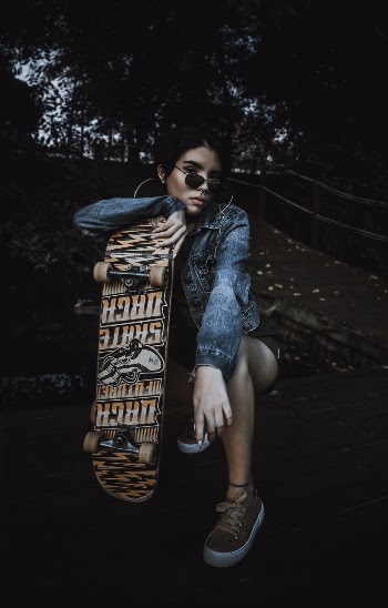 Photo of Woman Holding Skateboard