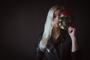 Photo of Woman Holding Skull Mask