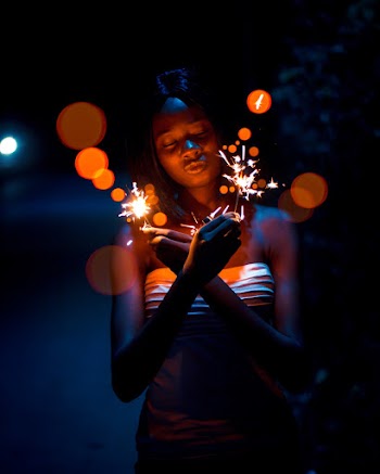 Photo of Woman Holding Sparklers