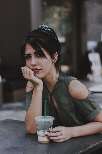 Photo of Woman Holding Starbucks Disposable Cup