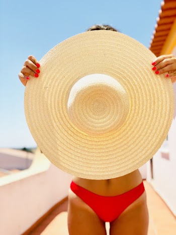 Photo of Woman Holding Straw Hat