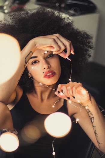Photo of Woman Holding String Lights