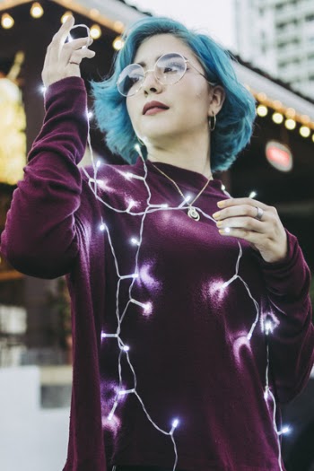 Photo of Woman Holding String Lights