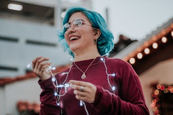 Photo of Woman Holding String Lights