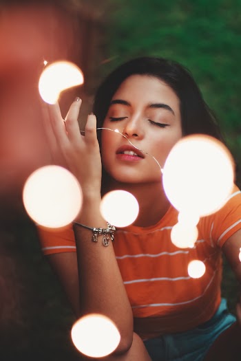 Photo Of Woman Holding String Lights