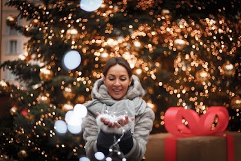 Photo of Woman Holding String Lights